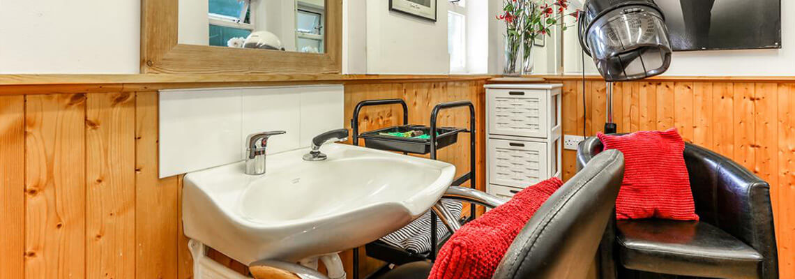 Hair salon station with a sink and chair