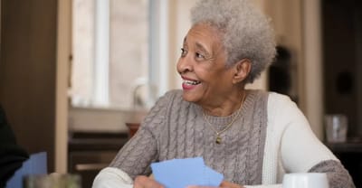Smiling resident engaged in an indoor activity