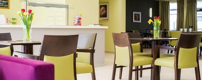Bright dining area with colorful floral arrangements