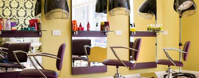 Interior view of a hair salon with styling chairs and equipment