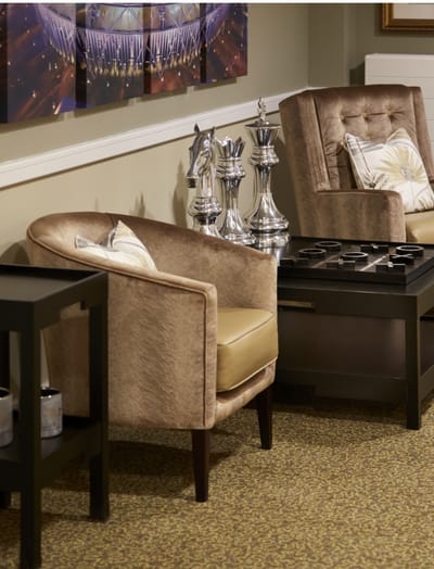 Cozy common area with chess set and armchairs