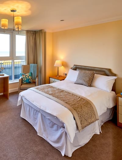 Cozy private resident room with a bed and chair