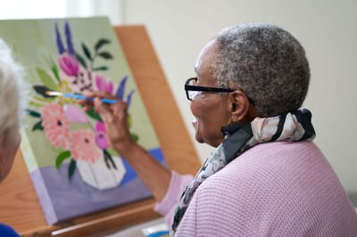 Resident painting in an art activity class
