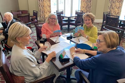 Residents enjoying a card game in a common area