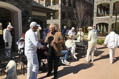 Residents enjoying an outdoor gathering with staff