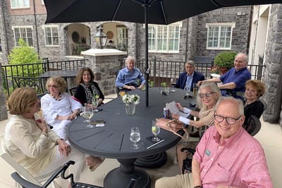Residents enjoying a social gathering outside at a table