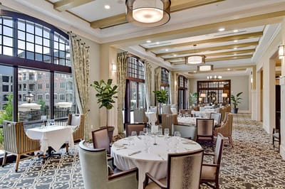 Elegant dining room with tables set for residents