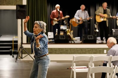 Residents enjoying a live band performance in a common area