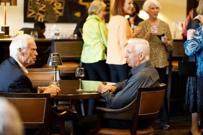 Two residents chatting in a lively common area