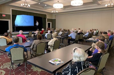 Residents attending a presentation in a large common area