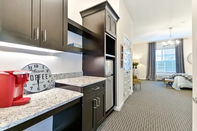 Interior view of a resident's room with kitchenette