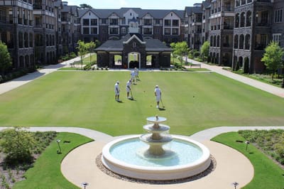 Residents playing croquet on the lawn
