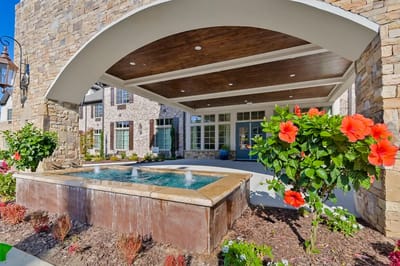 Entrance area with a fountain and vibrant flowers