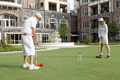 Residents playing croquet on the lawn
