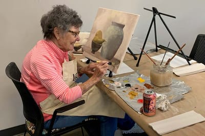 Resident painting in an art class