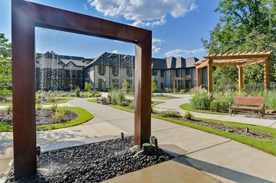 Beautiful landscaped outdoor space with a water feature