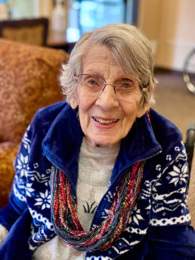 Smiling elderly woman in a cozy indoor setting