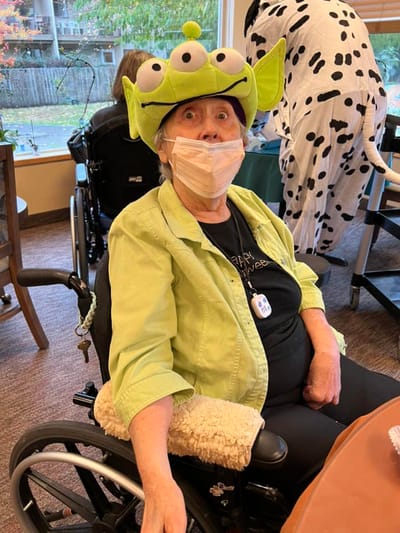 Resident wearing a playful alien hat in a common area