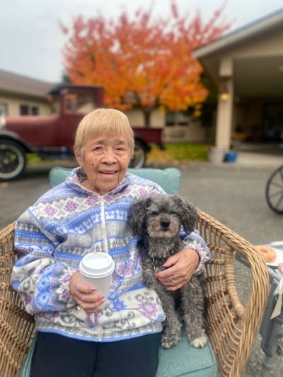 A resident enjoying time outdoors with a small dog