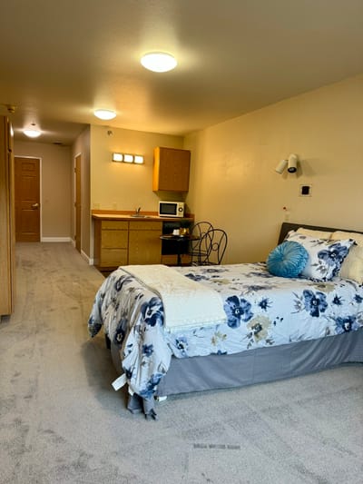 Cozy resident room with bed and kitchenette