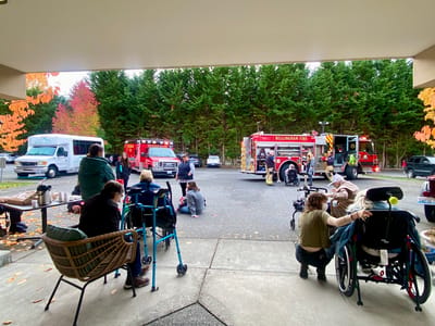 Residents observing a fire truck outside the facility