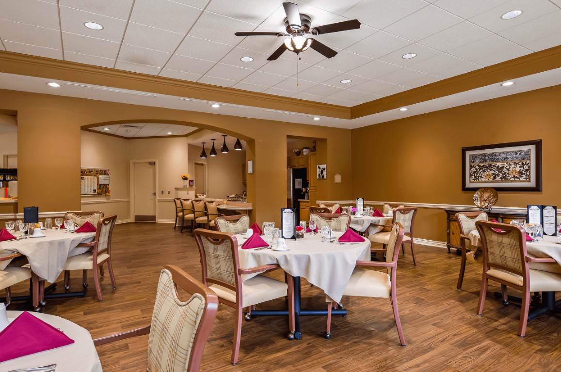Dining room set up for residents with tables and decor