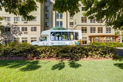 Facility shuttle bus in front of The Plaza at Punchbowl