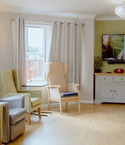 Comfortable interior common area with armchairs and TV