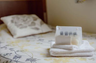 Towels and toiletries arranged on a bed