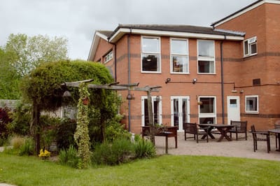 Outdoor patio area with garden and seating