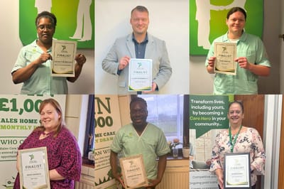 Staff members displaying awards and certificates