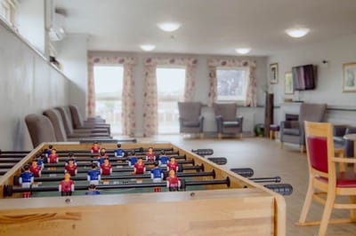 Foosball table in a common area with seating