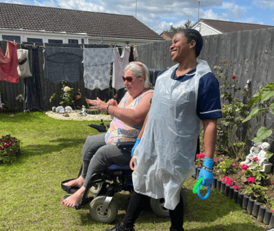 Resident and caregiver enjoying time in the garden