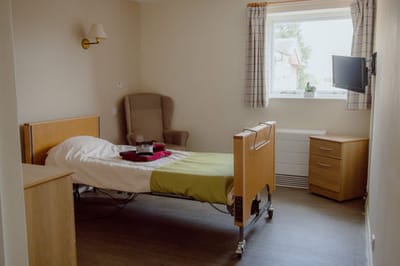 Cozy resident room with bed and chair