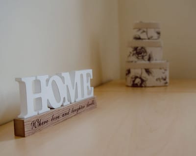 Decorative 'HOME' sign with heartfelt message