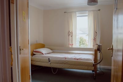 Cozy private room with a hospital bed