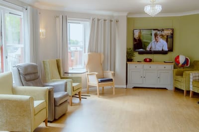 Common area with chairs and a TV.