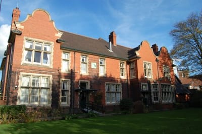 Exterior view of a red brick building with greenery