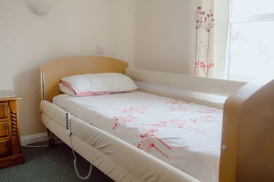 A simple, unoccupied resident room with a bed.