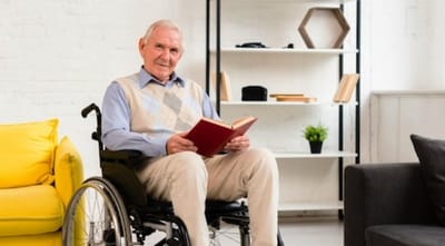 Senior man reading a book in a cozy interior
