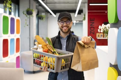 Man holding a food basket in a modern space