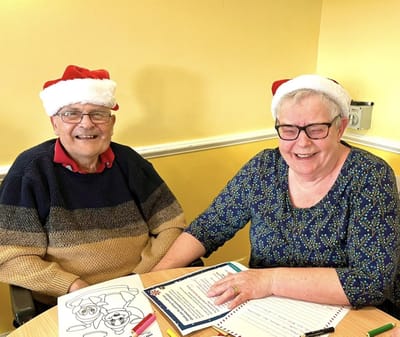 Cedar Court Care Home, memory care in Peterborough, UK — Seniors wearing festive hats while engaging in activities