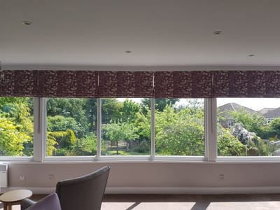 View of a sunny common area with large windows