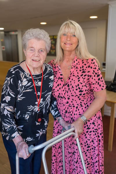 Resident and staff member in a common area