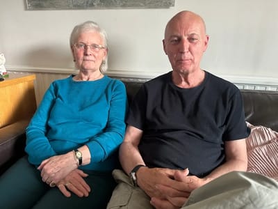 Two residents sitting together in a common area.