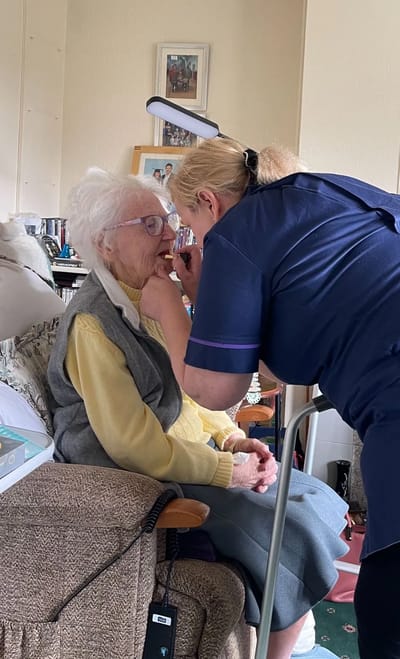Senior woman being assisted by caregiver