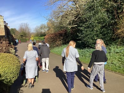 Staff and residents enjoying an outdoor walk.