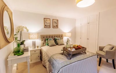 Cozy bedroom with a bed and decorative elements.