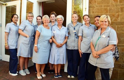 Group of staff members smiling together