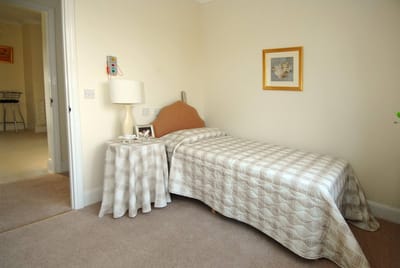 Cozy resident room with single bed and decor.